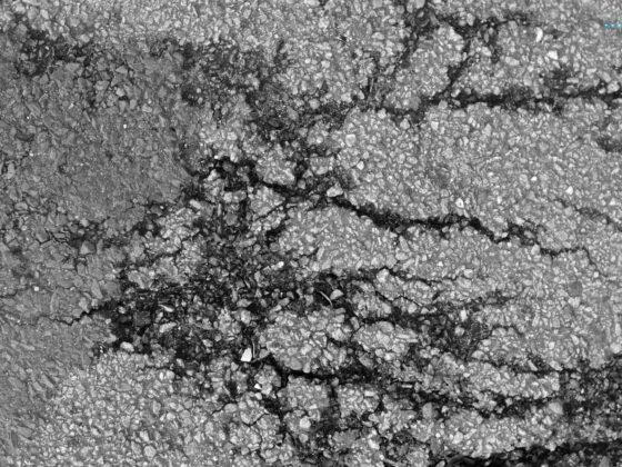 shattered dreams black asphalt with cracks