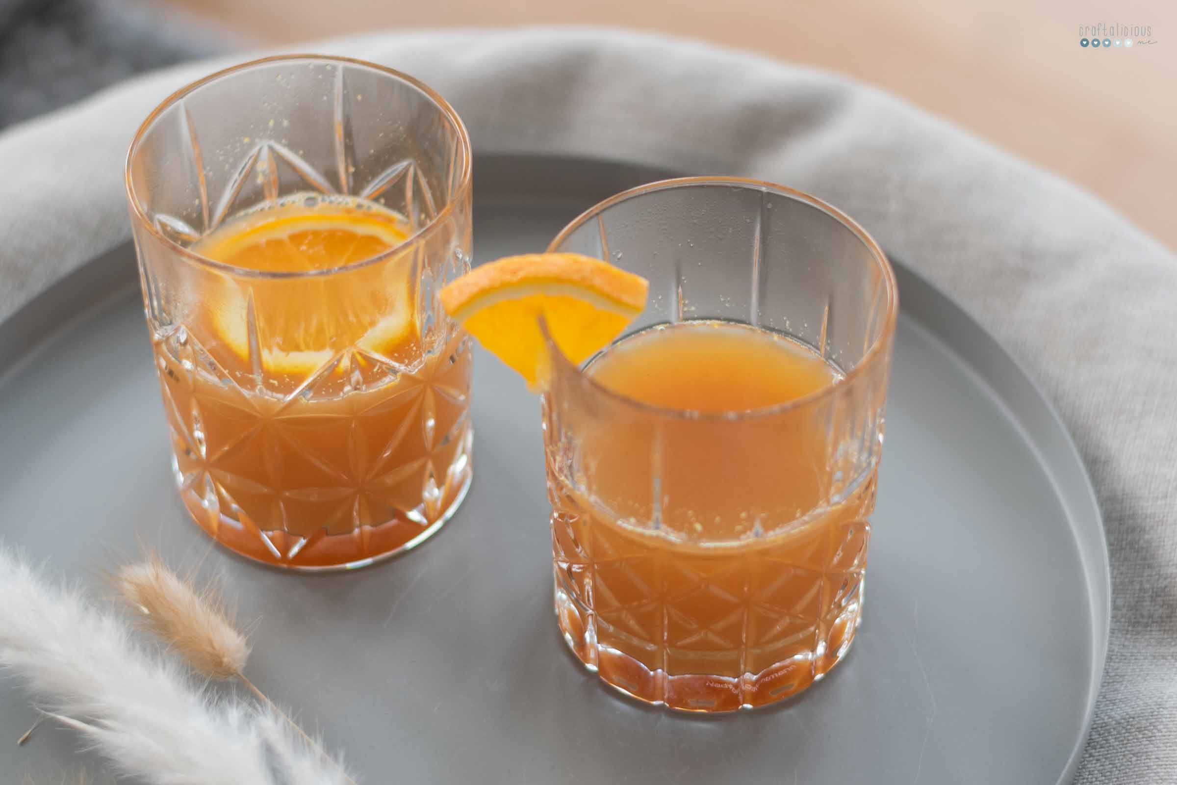 hot orange punch for cold days in stylish whiskey mugs