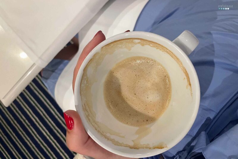 virtual coffee date July empty cup of coffee from top in hand with red nails