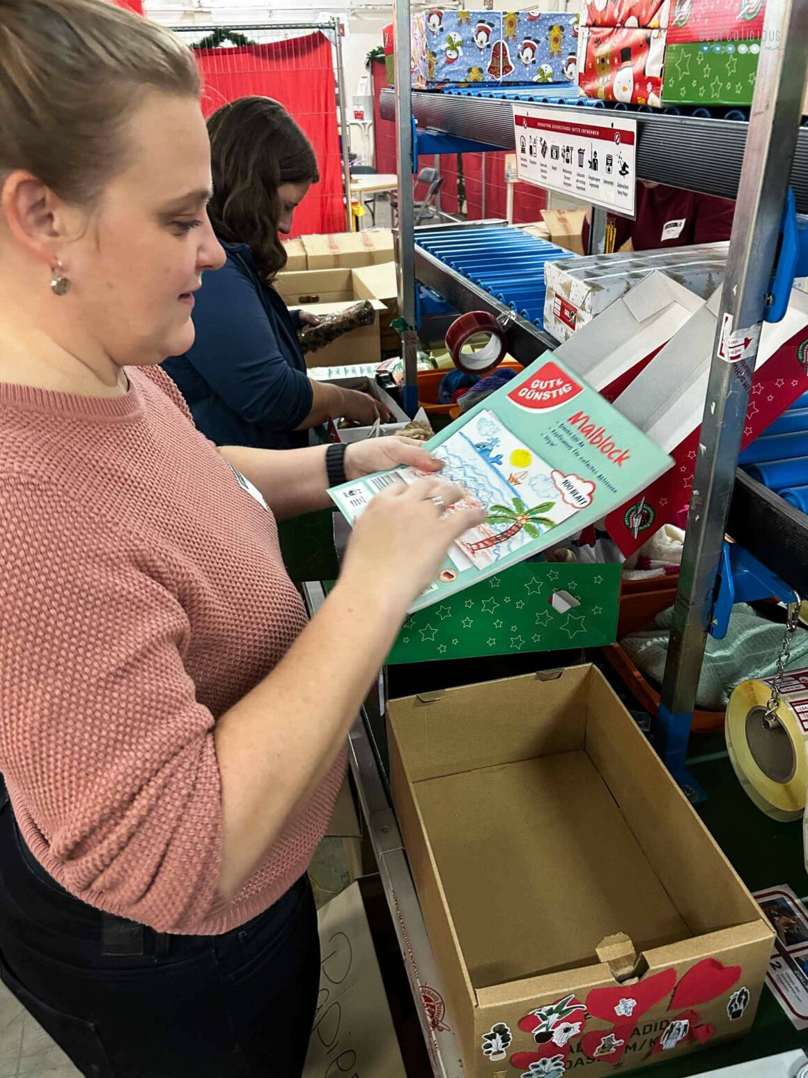 sisterly tradition checking boxes in the Christmas factory for operation Christmas child