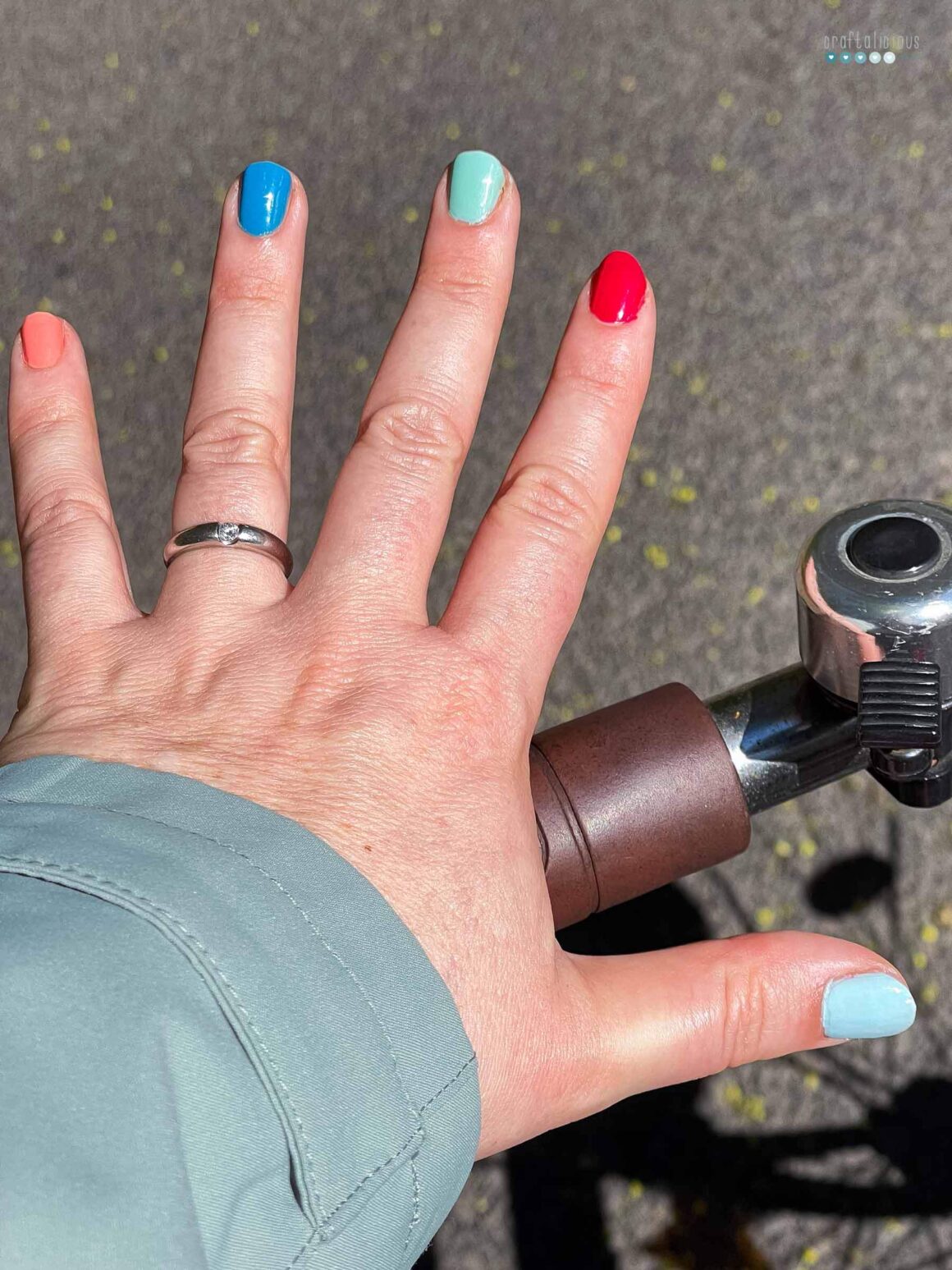 hand with five different colored nails