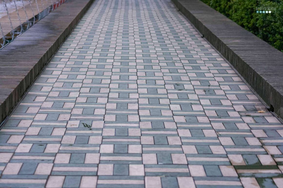 a walkway with different colored tiles in a repeating pattern