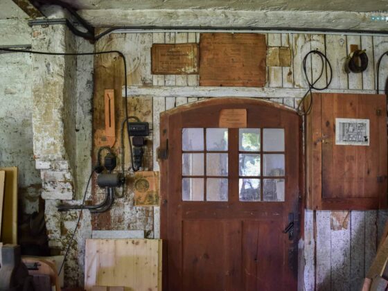 wall of an old workshop with instructions on paper glued to it