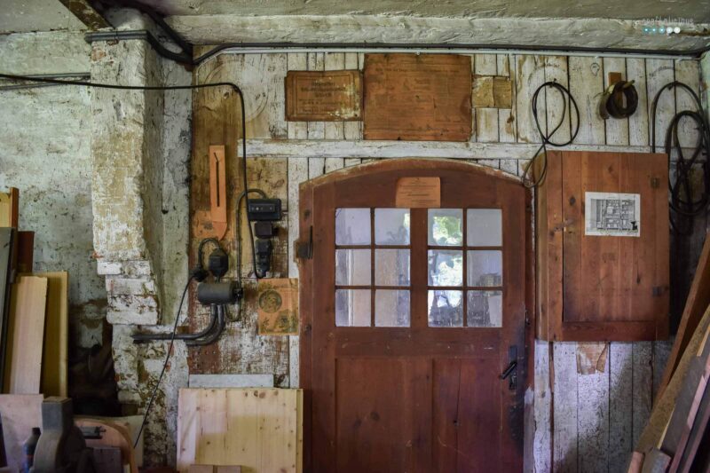 wall of an old workshop with instructions on paper glued to it