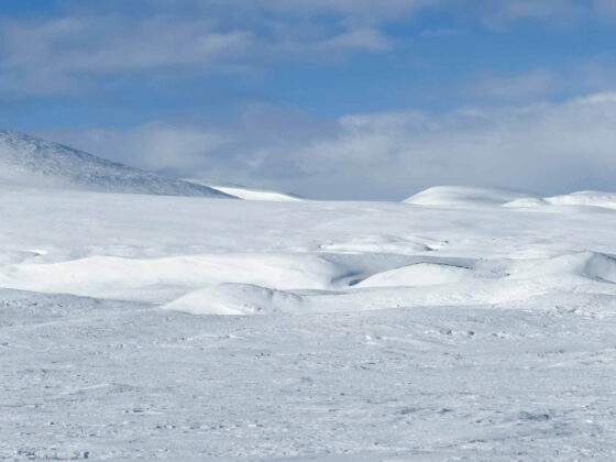 MyArcticAdventure beautiful hilly artic landscape in bright sunshine with blue skies and a few clouds