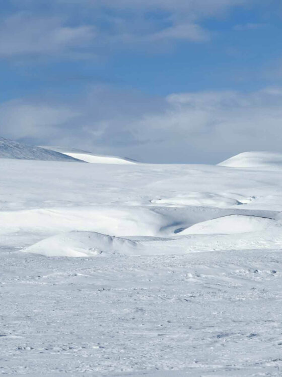 MyArcticAdventure beautiful hilly artic landscape in bright sunshine with blue skies and a few clouds
