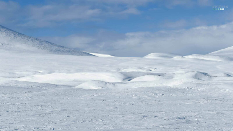 MyArcticAdventure beautiful hilly artic landscape in bright sunshine with blue skies and a few clouds