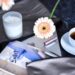 still life from desk situation with pen, bullet journal, coffee and flowers